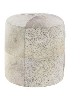 a white and grey stool with black spots on it's sides, sitting in front of a white background