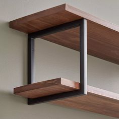 two wooden shelves with metal brackets on them