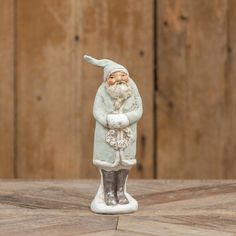 a figurine is standing on a wooden table