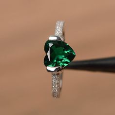 It is a lab emerald ring. The main stone is 8mm*8mm heart cut, weight about 1.59 carats. The basic metal is sterling silver and plated with rhodium. To change the metal to a solid gold (white/rose) or platinum is also available, please ask for a quotation if you want. You can also go to my shop Home for more elegant rings: https://www.etsy.com/shop/godjewelry?ref=hdr_shop_menu More emerald rings: https://www.etsy.com/shop/godjewelry/items?ref=seller-platform-mcnav&section_id=20709240 Customi Elegant Green Heart Promise Ring, Elegant Green Heart Sterling Silver Ring, Elegant Green Sterling Silver Heart Ring, Green Heart Ring For Wedding And May Birthstone, Green Heart Ring For May Birthstone, Green Heart Ring For May Birthstone Wedding, Green Heart Ring For Wedding With May Birthstone, Green Heart Ring For Wedding, May Birthstone, Fine Jewelry Green Heart Ring For May Birthstone