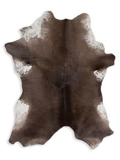 a brown and white cowhide rug on a white background