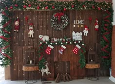 christmas decorations are displayed on the side of a wooden wall