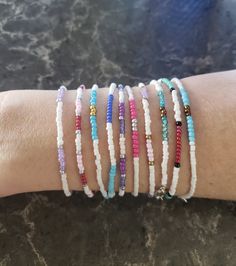 This listing is a collection of 10, dainty minimalistic beaded bracelets! Boho stackable bracelets strung on strong beading string, very durable making them perfect for everyday wear. Wonderful gift for someone or yourself! Each bracelet is sold separately and numbered in pictures 2, 3, and 4 so you can make sure you're getting the right bracelet. Comes in many sizes, and let me know if you don't see yours! All of our jewelry comes gift-wrapped in a little bag, making them the perfect gifts for best friends, gifts for her or to treat yourself! Or would be cute friendship bracelets. They ship very quickly! Spice up your jewelry collection with these beaded bracelets. If you have any questions or anything else feel free to contact me! Seed Beaded bracelets All hand-made by simplyradiantjewel Stackable Heishi Beads Friendship Bracelets, Dainty Hypoallergenic Beaded Bracelets, Minimalist Beaded Stretch Bracelet For Gift, Handmade Minimalist Adjustable Stretch Bracelet, Dainty Adjustable Beaded Bracelets With Tiny Beads, Adjustable Dainty Stretch Bracelet, Minimalist Tiny Beads Stretch Bracelet As Gift, Minimalist Stretch Bracelet With Tiny Beads As Gift, Adjustable Dainty Heishi Beads Bracelets