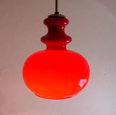 a red light hanging from a ceiling in a room