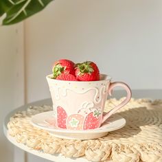 two strawberries in a cup on a table