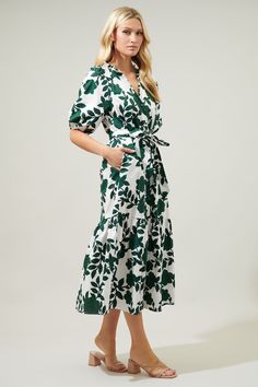 Step out in an evergreen, floral state of mind. Sweet, green floral motifs sit against a cool and crisp, white-ground to shape the Wynette Dress. A shift maxi with bubble sleeves that frame a functional button front dress. It maintains a sheath silhouette, with a sash style belt to add shape.The buttons end where they meet a bottom tier split.- Breathable - Belted- Button front- Pockets- Color: White ForestSize + Fit - Model is 5'8" and wearing size XS- Measurements taken from size S - Chest: 19 Hem Finishes, Spring Business Casual, Baltic Born, Mock Neck Blouse, Button Front Dress, Tiered Midi Dress, Midi Length Skirts, Head Over Heels, White Midi Dress