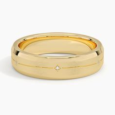 a yellow gold wedding band with diamonds