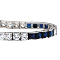 This wonderful vintage piece features 9.80ctw of vibrant blue sapphires combined with 5.30ctw of sparkling round brilliant cut diamonds. The diamonds are graded G-H in color and VS1-2 in clarity and form a beautifully dramatic contrast to the deep blue sapphires. A stunning Mid Century era treasure set in platinum, this bracelet fastens securely with a push style clasp, and has a hidden safety latch. This bracelet measures 7.25 inches long. It has been independently appraised at a value of $25,0 Formal Blue Platinum Bracelet, Classic Sapphire Bracelet With Prong Setting, Luxury Blue Diamond Bracelet With Brilliant Cut, Blue Diamond Bracelet With Brilliant Cut Luxury Style, Blue Diamond Platinum Bracelet For Formal Occasions, Classic Blue Cubic Zirconia Tennis Bracelet, Formal Blue Diamond Platinum Bracelet, Blue Diamond Jubilee Tennis Bracelet, Classic Sapphire Tennis Bracelet With Prong Setting