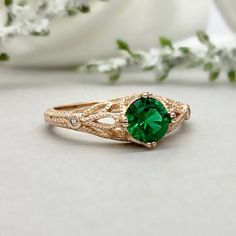 a close up of a ring with a green stone