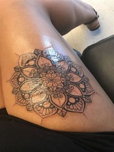 a woman's thigh with an intricate tattoo design on the thighs and leg area