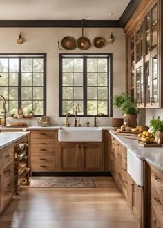 a kitchen filled with lots of wooden cabinets and counter top space next to a window