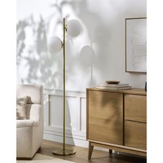 a living room scene with focus on the floor lamp and sideboard cabinet in the foreground