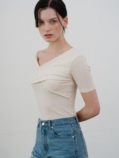 This is a comfortable and trendy top by ourcomos that is made out of high quality polyester and spandex blend fabric. With refined design detail with trendy look, it will stand out from your casual and feminine daily outfit.- Cross over detail on the front- Unbalanced off shoulder- Slim silhouette and feminine mood Versatile Fitted T-shirt For Spring, Versatile Beige V-neck Top, Versatile Stretch Short Sleeve Top, Stretch Short Sleeve Spring Tops, Fitted V-neck Elastane Top, Stretch Elastane Short Sleeve Tops, Stretch Short Sleeve Tops For Spring, Trendy High Stretch V-neck Tops, Trendy Soft Stretch Tops For Spring