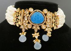 This is a beautiful set with intricate details and comes with a matching set of earrings. The finish is in a beautiful gold and is a simple yet elegant necklace that can be paired with any outfit. There are 4 different colors available in this style along with matching earrings. Elegant Blue Kundan Necklace With Intricate Design, Bollywood Blue Bridal Necklace Hand Set, Traditional Blue Festive Choker, Blue Kundan Necklaces For Reception, Blue Kundan Necklace For Reception Festivities, Blue Kundan Necklace For Festive Reception, Blue Bollywood Necklace For Receptions, Blue Kundan Necklace With Intricate Design For Festive Occasions, Blue Kundan Necklace For Reception And Festive Occasions