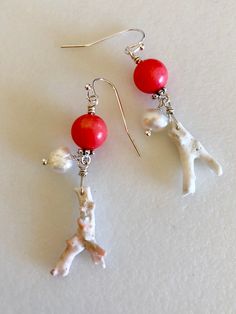 "Lovely pale orange shade of pink coral with natural white coral twigs and white freshwater pearls in choice of Sterling silver or 14k gold fill earrings. Genuine 10 mm pink coral rounds are dyed a delicate pale orange color and wire wrapped with 20mm long natural white coral twigs. White 6/7mm cultured freshwater pearls add accent. Beautiful ocean treasures hang from simple French hooks. Total drop length is 2\". Available in .925 Sterling silver or 14k gold fill." Coral Pearl Jewelry As A Gift, Coral Pearl Jewelry Gift, Coral Pearl Drop Jewelry As Gift, Coral Jewelry With Ear Wire For Gift, Coral Pearl Jewelry For Gift, Coral Jewelry Gift With Ear Wire, Coral Pearl Drop Jewelry Gift, Elegant Coral Jewelry With Pearl Drop, Elegant White Red Coral Jewelry