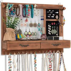 a wooden shelf with jewelry hanging from it's sides