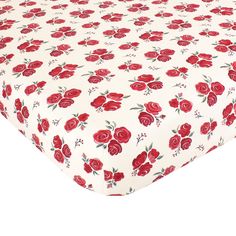 a white sheet with red roses on it