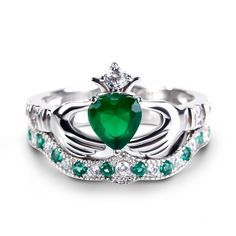 Celebrating love, beauty and Irish culture, this claddagh ring set will capture your heart at first sight. Crafted in sleek sterling silver, the ring features an emerald green heart center stone set on a high polished shank. The traditional claddagh ring is a meaningful token of loyalty, friendship and love. The hands represent friendship, the heart represents love and the crown represents loyalty.With the beautiful coordinating band, the ring is a dazzling look of love.Carat Weight: 1.4 ctStone Green Fine Jewelry Heart Ring For Wedding, Green Heart Cut Rings For Wedding, Green Heart Cut Wedding Rings, Heart-shaped Emerald Rings For Wedding, Elegant Green Sterling Silver Heart Ring, Green Heart Ring For Wedding With May Birthstone, Elegant Green Heart Sterling Silver Ring, Green Heart Ring For May Birthstone Wedding, Green Heart Ring For Wedding, May Birthstone