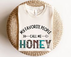 "My favorite people call me Honey Shirt. This cute Honey design is the perfect tshirt for wearing if you are a proud Gigi. Buy it for yourself or give it as the perfect birthday, Christmas or mothers day gift.  My favorite people call me Honey Shirt, Honey Gifts, pregnancy announcement, new Honey gift, grandma gift mothers day gift, birthday gift ⭐️HOW TO ORDER⭐️ Select your quantity of shirts in the specific colour/size and click \"ADD TO BASKET\"   Repeat as needed by returning to the listing Honey Grandma Shirt, Cute T-shirt With Custom Text For Gift, Cute Custom Text T-shirt For Gift, Honey Shirt, Honey Gift, Grandparents Shirt, Grinch Ornaments, Honey Gifts, Honey Design