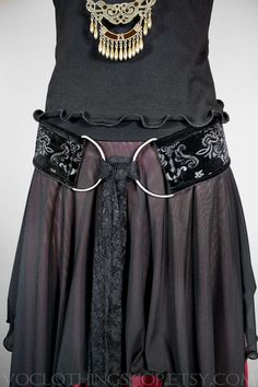 "** NEW ITEM ** BLACK EMBOSSED VELVET tie-front hip belt with BLACK VELVET TRIM, big gunmetal d-rings, extra long lace scarf, and heavy duty corset elastic backing. 100% handmade and animal friendly! WINE + CHAMPAGNE OMBRÉ SKIRT: https://www.etsy.com/listing/875709715/ SIZES + BELT LENGTHS: XS :: 29\" S :: 32\" M :: 35\" L :: 38\" XL :: 41\" XXL (2X) :: 45\" FOR AN IDEAL FIT, your belt length should measure a few inches smaller than your full hips: the widest part of your lower body. All orders Black Steampunk Corset Belt For Festival, Steampunk Black Corset Belt With Belt Loops, Black Fitted Corset Belt For Festivals, Fitted Black Corset Belt For Festival, Black Lace Gothic Corset Belt, Black Stretch Elegant Corset Belt, Black Gothic Corset Belt For Evening, Black Fitted Corset Belt With Belt Included, Black Corset Belt For Festival