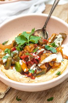 a white bowl filled with food on top of a wooden table