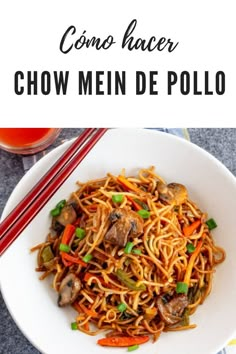 a white plate topped with chow mein and chopsticks