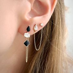 These earrings feature a unique design that combines multi-shaped black and white gemstones in a dangling chain. This design creates a sense of movement and elegance, adding a touch of sophistication to your ear stack. Luxury Black Drop Jewelry, Black Dangle Earrings Fine Jewelry, Black Dangle Jewelry With Adjustable Chain, Black Pierced Long Drop Jewelry, Black Long Drop Pierced Jewelry, Modern Black Long Drop Jewelry, Black Drop Jewelry With Pierced Details, Black Drop-shaped Pierced Jewelry, Elegant Black Earrings With Adjustable Chain