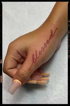 a woman's hand with the word believe written on it