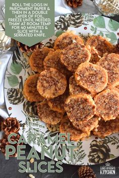 a plate full of cookies on top of a table with pine cones in the background