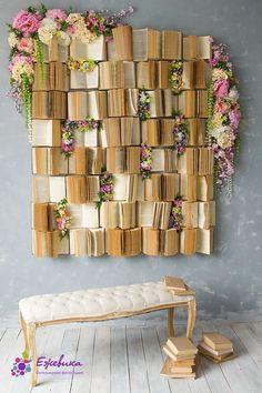 a bench sitting in front of a wall with books stacked on it's sides