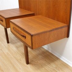 two wooden nightstands sitting next to each other on top of a hard wood floor