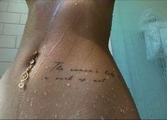 the back of a woman's stomach with words written in cursive writing