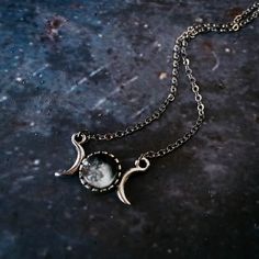 "Personalized and petite, this necklace is the perfect sentimental gift for your favorite stargazer. This pendant has the phase of the moon that was shining in the sky from the date of your choosing (past, present, or future) and is flanked by two crescent moons. Small enough for everyday wear, yet special enough to be treasured. To order, please provide the following information : Date (in this format: MM/DD/YYYY), Time Zone, and Approximate Time Of Day (if possible) of the date you wish to cel Mystical Nickel Free Moon Necklace, Nickel Free Mystical Moon Necklace, Mystical Nickel-free Moon Necklace, Nickel-free Mystical Moon Necklace, Symbolic Metal Necklace With Moon Phase Detail, Half Moon Metal Necklace For Gift, Half Moon Metal Necklace For Gifts, Celestial Metal Necklace With Moon Phase, Celestial Metal Moon Phase Necklace