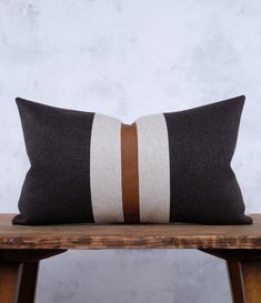 a brown and white pillow sitting on top of a wooden table