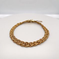 A very fine 14k gold Etruscan style bracelet.  With three delicate strands of woven braided gold wire terminating in an Etruscan style box clasp with granulated and wire work decoration.   Set with a safety chain.  Simply a finely-made Etruscan style bracelet!  Date: 20th Century  Overall Condition: It is in overall good, as-pictured, used estate condition with some very fine & light surface scratches and other signs of expected light wear consistent with age.  Fineness: Marked 14k for gold fine Elegant Bracelets With Interwoven Design As Gift, Elegant Bracelets With Interwoven Design For Gift, Luxury Adjustable Braided Jewelry, Elegant Gold Bracelet With Wheat Chain As A Gift, Elegant Yellow Gold Jewelry With Interwoven Design, Gold Wheat Chain Bracelets As Gift, Yellow Gold Bracelets With Wheat Chain As A Gift, 14k Gold Wheat Chain Bracelet Gift, Elegant Gold Braided Bracelet For Formal Occasions