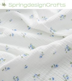 a white sheet with blue flowers on it and the words springdesigncrafts