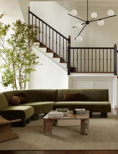 a living room filled with furniture and a stair case