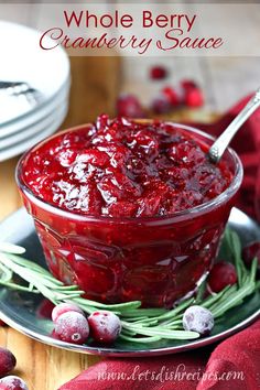 cranberry sauce in a glass bowl with rosemary sprigs on the side