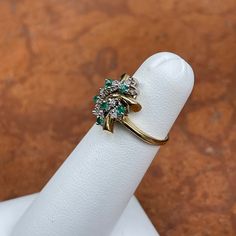 Estate 14KT yellow gold ring with genuine emerald and diamond cluster designand prong-set diamonds in white gold. Makes a FAB Mid-Century ring! Size 3.5 Weight: 3.26 grams Lively, emeralds and diamonds Lots of sparkle, not dead looking emeralds! Not Stamped 14K, but tested and guaranteed Excellent estate piece Diamond Cluster Emerald Promise Ring, Cluster Diamond Emerald Ring For Promise, Cluster Diamond Emerald Promise Ring, Fine Jewelry Emerald Cluster Ring With Diamond Accents, Green Cluster Diamond Ring, Formal Cluster Emerald Ring, Emerald Cluster Ring In White Gold, White Gold Emerald Cluster Ring, Green Cluster Diamond Ring Fine Jewelry