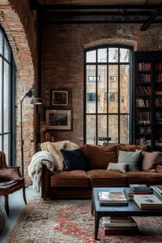 a living room filled with lots of furniture next to a brick wall covered in windows