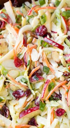 a salad with apples, cranberries, and almonds in it is ready to be eaten