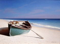 a small boat on the beach near the ocean