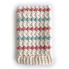 a crocheted dishcloth with pink, blue and white stripes on the side