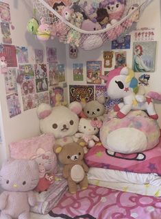 there are many stuffed animals on the bed and in the room with it's pink comforter