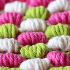 many different colored crocheted yarns are arranged together