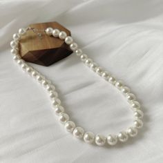 The Classic Pearl Necklace gives off ultra feminine vibes. Every girl needs one in their collection. Made up of real freshwater pearls Perfect for daily wear or on a night out. Material: Freshwater PearlsLength: 43+3cm Tarnish Free Hypoallergenic Glazd Pouch with every order Free US shipping Easy Exchange & Return policy PRODUCT INFOThis necklace is made of Full Sterling Silver 925 material, not just plated. We added rhodium plating and our organic coating. This means the color will last for a r Chic White Round Necklace, Classic Pearl White Necklace With Clavicle Chain, Elegant Pearl White Beaded Necklace With Clavicle Chain, Elegant Round Pearl Chain Beaded Necklace, Elegant Pearl Chain Beaded Necklace, Long Pearl Necklace For Party, White Pearl Charm Necklace For Party, Akoya Pearl Beaded Necklace With Pearl Charm, Beaded Akoya Pearl Necklace With Pearl Charm