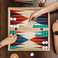 two people playing a board game on a table