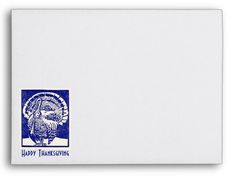 a white envelope with a blue thanksgiving turkey stamp on the front, and an image of a turkey