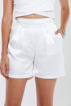 Discover the perfect blend of style and comfort with our high-waisted effortlessly pleated shorts. Made from a premium mix of 96% Poly and 4% Spandex Alitrech Satin, these shorts offer a luxurious, silky feel against your skin. The high-waisted silhouette and pleated design flatter your figure while providing all-day comfort and ease of movement. Featuring deep side pockets and a subtle sheen from the Alitrech Satin, these shorts transition seamlessly from casual outings to more polished looks. Elegant High Waist Shorts For Day Out, Elegant Shorts For Day Out, Summer Pleated Bottoms For Night Out, Chic High-waist Shorts With Elastic Waistband, Chic Shorts With Elastic Waistband, Solid Short Pleated Bottoms, High Waist Solid Pleated Shorts, Summer Pleated Solid Shorts, Solid High Waist Pleated Shorts