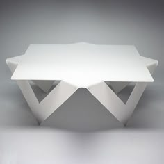 a white table sitting on top of a gray floor